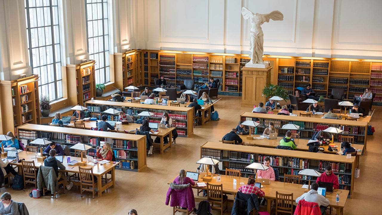Student studying in the reading room at Thompson Library
